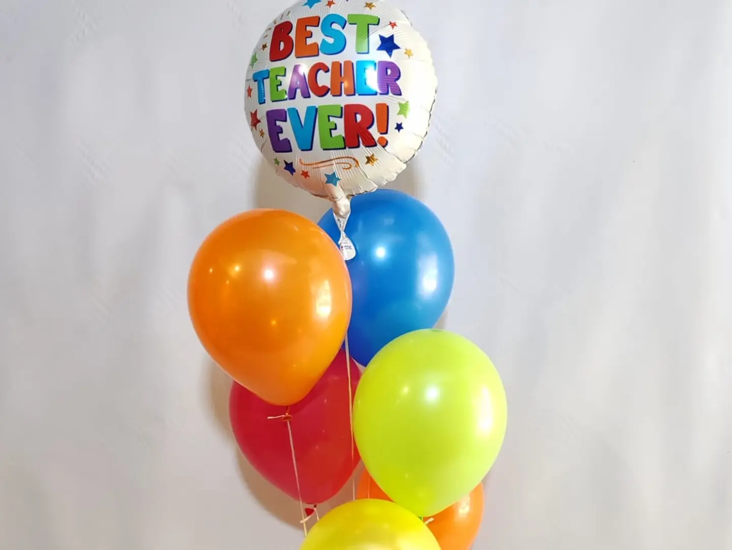A Bouquet Of Balloons With One Balloon That Says Best Teacher Ever