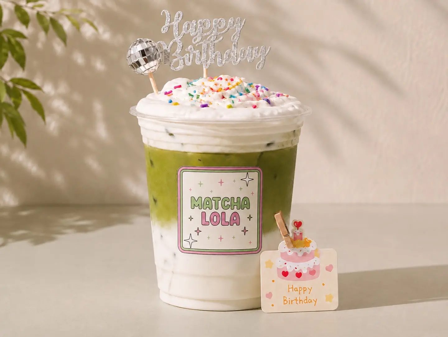 Celebration Style Matcha With Cream, Colorful Sprinkles, A Birthday Candle, And Special Decorations On Top Of The Cup.