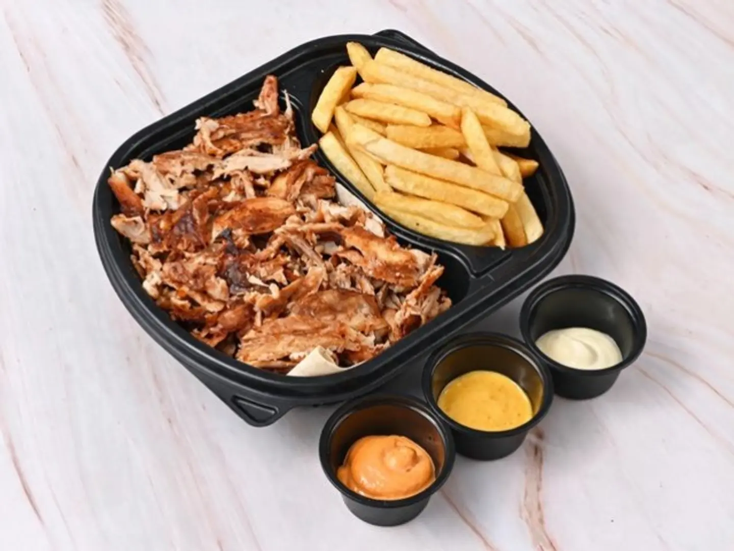 A Plate Of Chicken Shawarma Slices With French Fries.