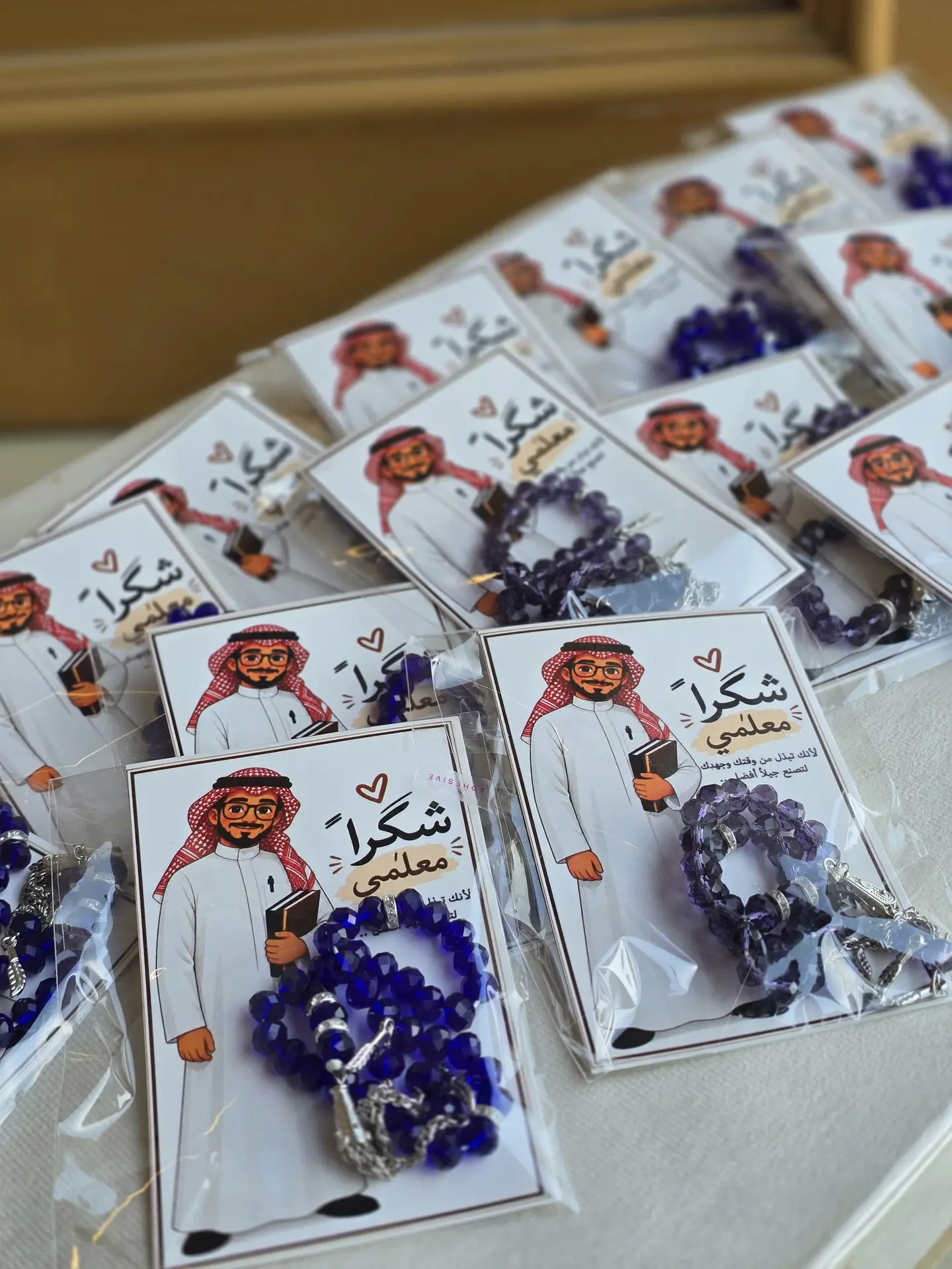 A Prayer Beads Packaged With A Card Bearing The Teacher's Day Logo.